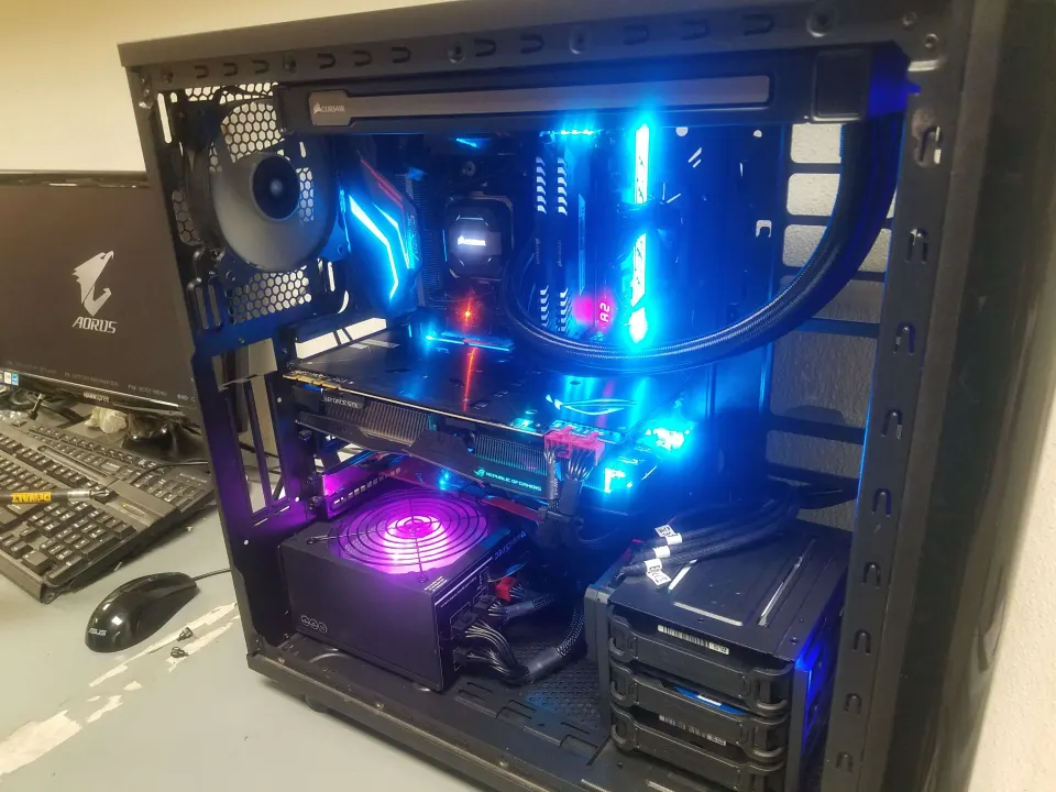 A custom gaming PC with a liquid cooler and glowing blue and purple lighting